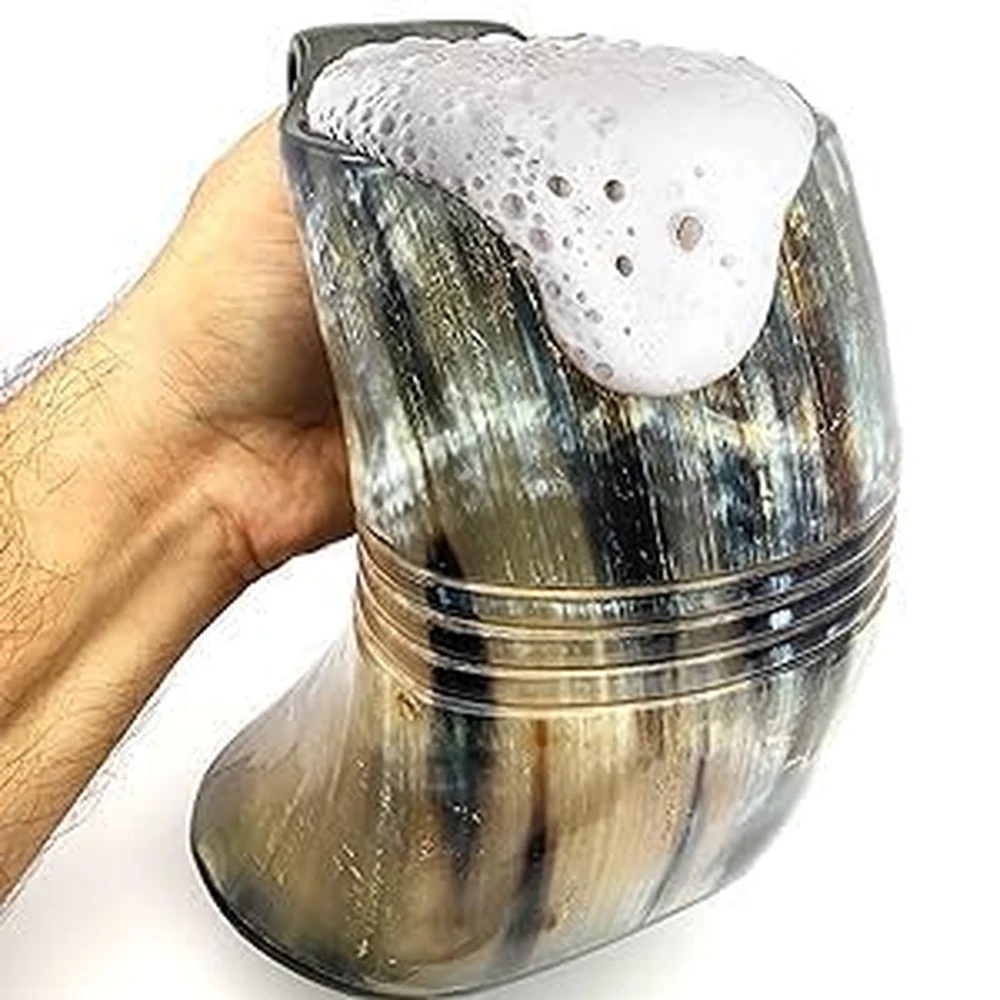 Natural ox horn beer mug filled with beverage Natural ox horn beer mug filled with beverage