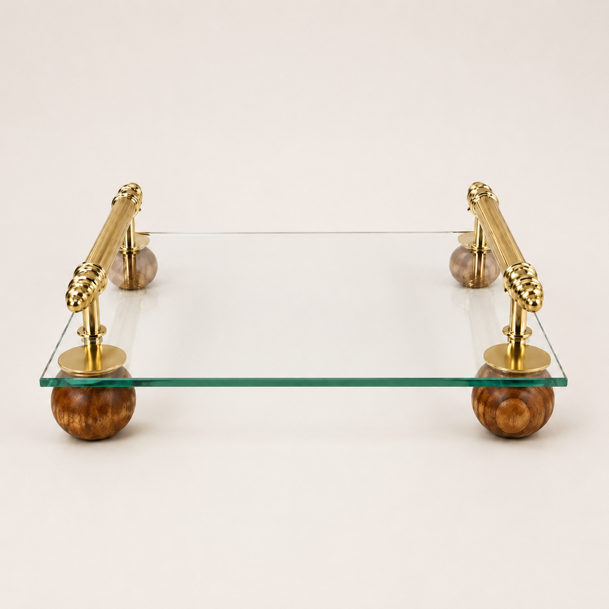 Luxury tempered glass serving tray with gold metal handles and wooden ball feet for serving drinks, desserts and home décor. Luxury Glass Serving Tray with Gold Metal Handles