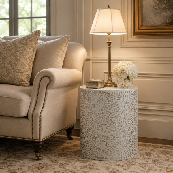 Handcrafted floral bone inlay drum table with lamp beside upholstered sofa