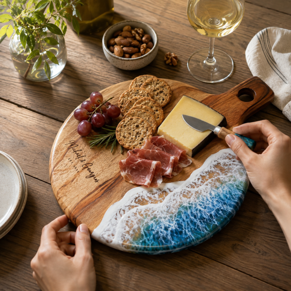 Handcrafted natural wooden chopping board with handle used for cutting meat, cheese and bread in a modern kitchen.