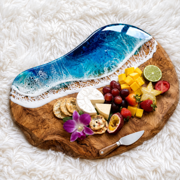 Handcrafted wooden and epoxy resin ocean serving board with cheese and fruits