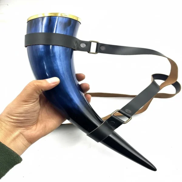 Blue ceramic horn mug in historical-inspired setting