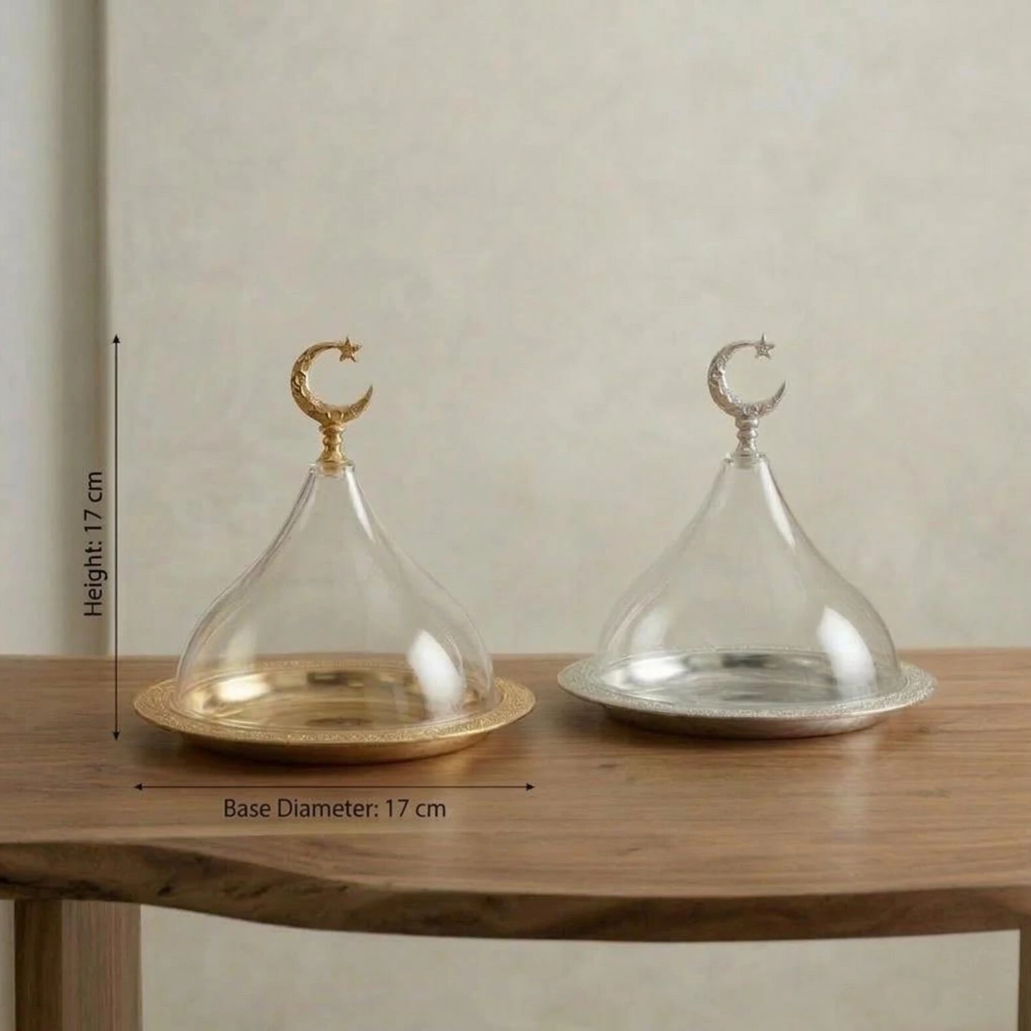 Crescent glass cloche serving stand with decorative metal base Crescent glass cloche serving stand with decorative metal base