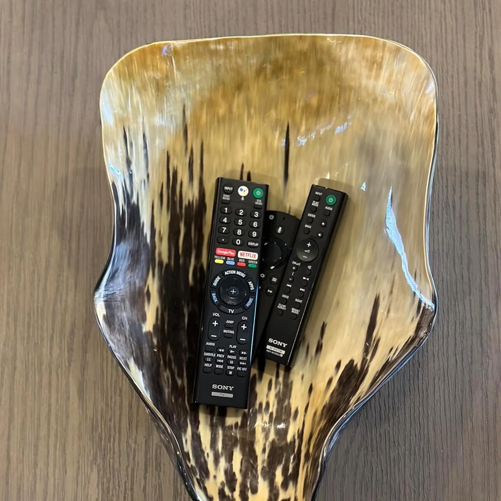 natural-horn-bowl-polished-finish.webp Polished natural horn bowl with organic brown and amber pattern